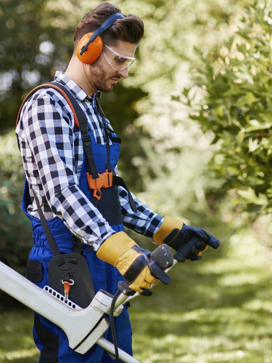 man-with-weedwacker-cutting-the-grass